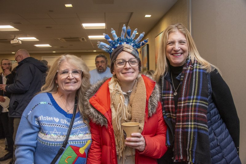 Enjoying the festivities as they gather for the menorah lighting are (l-r) Beth Berch, Alexandra Miller and Wendy Weiss.